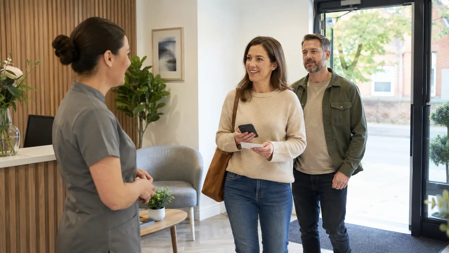 A woman and her companion arriving at a dental practice for assessment